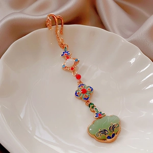 Close-up of 14k gold plated pearl flower brooch with vintage enamel and jade pendant detail