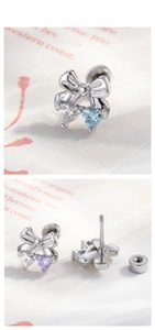 Macro detail of bow-shaped stud earrings with heart cubic zirconia and screw back closure