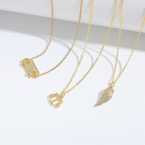Golden necklace set with bus, libra, and wing pendants featuring sparkling cubic zirconia