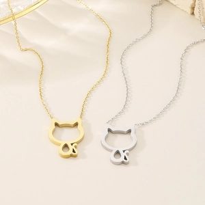 Close-up of gold and silver stainless steel necklaces featuring cutout cat pendants