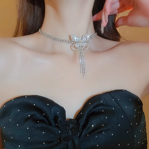 Silver butterfly necklace with sparkling zircon tassels worn by a female model