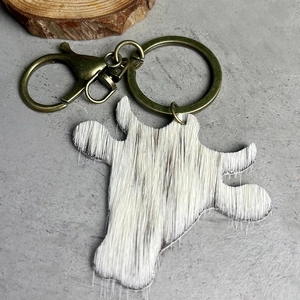 Vintage western bull head keychain featuring brown and white cowhide and bronze hardware
