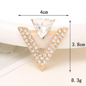 Detailed view of V-shaped gold brooch with triangle gem, size 4cm by 3.8cm