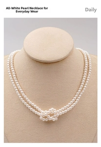Detail view of double-layered white pearl necklace with knotted design on beige stand