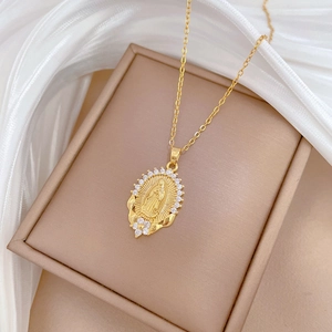 Close-up of gold-plated Virgin Mary oval pendant necklace with sparkling zircon details