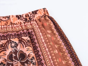Close-up of elastic waistband on bohemian wide-leg trousers with ethnic floral pattern