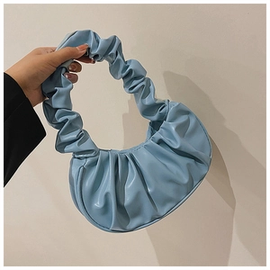 Detail of the light blue pleated handbag showing soft PU leather texture and cloud handle