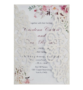 Detail of laser-cut ivory glitter wedding invitation with elegant pink floral inner card