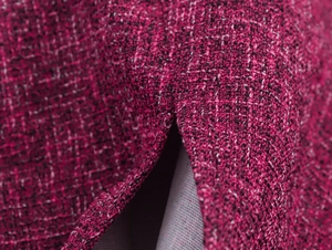 Close-up of elegant magenta tweed fabric texture with woven pattern and grey lining