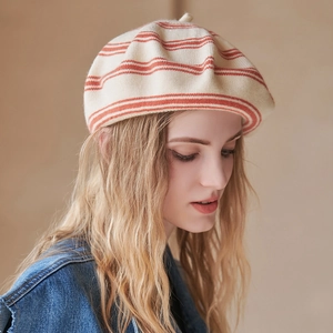 Chic cream wool beret with red stripes shown on a blonde model for autumn style