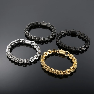 Close-up of punk skull bracelets in silver, gold, gunmetal, and black plated steel