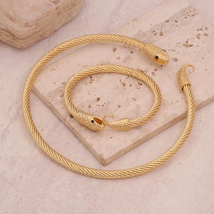 Set collana e bracciale a serpente dorati con trama a corda su base di pietra