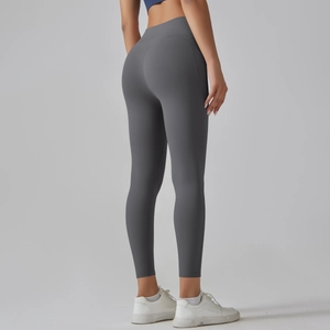 Side view of high-waisted seamless grey yoga pants showing supportive compression fit