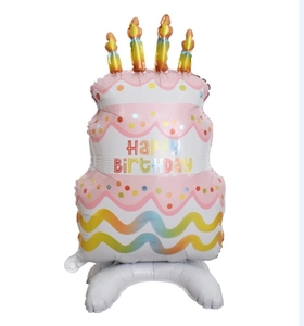 Close-up of pink birthday cake foil balloon with candles and standing base