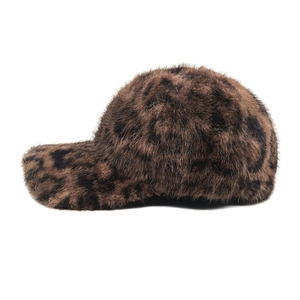Close-up of fluffy faux fur texture and leopard pattern on a stylish winter baseball cap