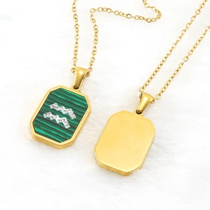 Macro detail of gold Aquarius necklace with green striped inlay and sparkling rhinestones