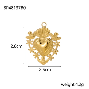 Detailed view of a gold hollow heart pendant with intricate bird and floral carvings