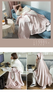 Pink hooded rabbit ear blanket used as a cozy sofa throw and office knee wrap