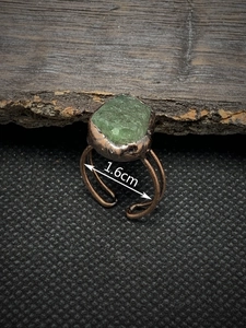 Macro shot of adjustable copper ring featuring raw green gemstone and 1.6cm diameter mark