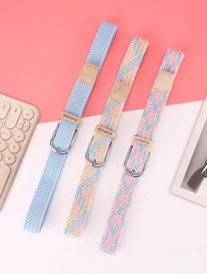 Three woven elastic belts with silver metal buckles in blue, pink, and yellow patterns