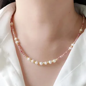 Detail of handmade beaded necklace featuring pink natural stones and freshwater pearls