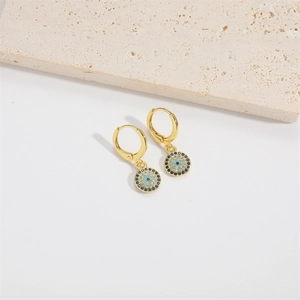 Detail of golden Evil Eye drop earrings with blue, white and black zircon inlays