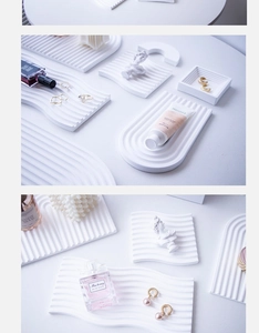 Close-up of wavy arched plaster trays for jewelry and cosmetics photography props