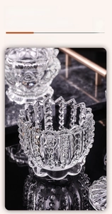 Detail of thickened transparent glass jar with beaded texture on dark marble surface