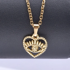 Close-up of 18k gold plated heart pendant with evil eye motif on stainless steel chain