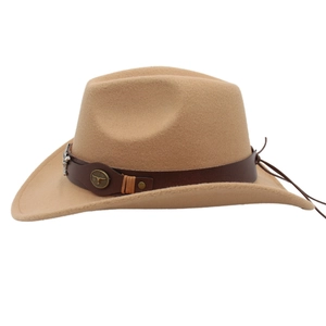 Detail of western cowboy hat featuring brown leather band and metal bull head ornament