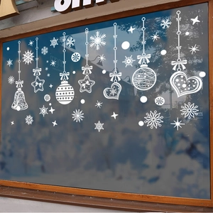 White snowflake window stickers with bells and stars on glass for Christmas decoration