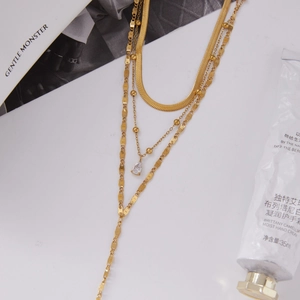 Detail view of layered 18K gold stainless steel snake chain with teardrop zircon pendant