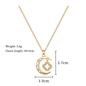 Detail showing gold crescent moon clover necklace with crystal inlay and 3.6g weight specs