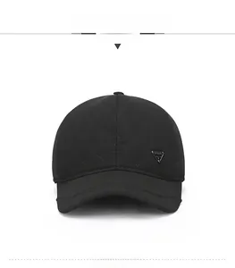 Close-up of black quilted baseball cap featuring diamond texture and metal triangle logo