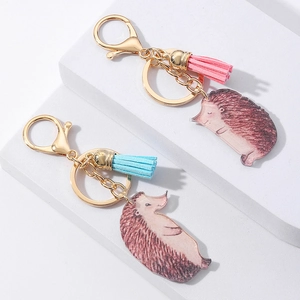 Detail of hedgehog couple keychains with colorful tassels and realistic acrylic charms