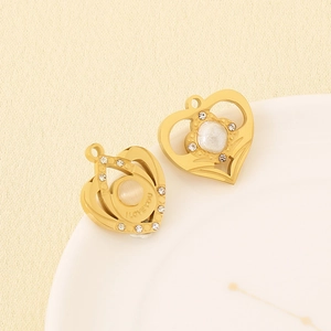 Detail of golden heart pendants with rhinestones, pearls and I LOVE YOU engraving