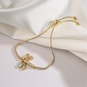 Detail showing gold dragonfly pendant with evil eye and adjustable box chain
