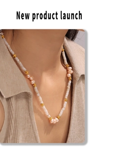Baroque necklace with natural freshwater pearls and golden star beads on a female model