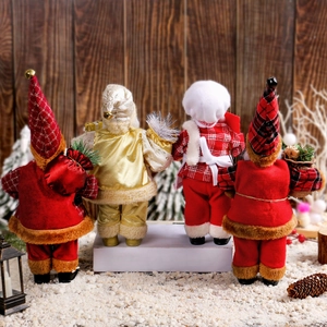 Back view of four standing Santa Claus figurines with plush red and gold outfits