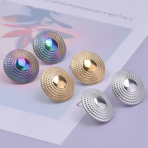 Macro detail of geometric 304 stainless steel earrings in gold, silver and rainbow finish