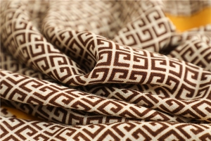 Macro shot showing brown and beige geometric pattern on soft linen cotton blend scarf