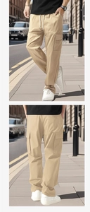 Detail of khaki men's straight-leg cargo pants with large side pockets in urban setting