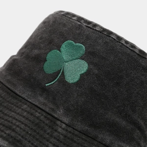 Washed dark gray cotton bucket hat featuring detailed green shamrock embroidery