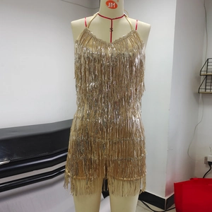 Detail of gold fringe tassels and sequins on a backless halter neck vacation dress