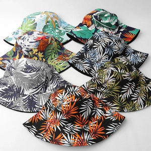 Tropical palm leaf print bucket hats in multiple colors for sun protection and beach wear