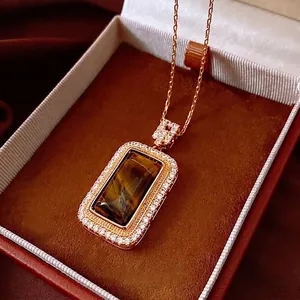 Elegant gold plated necklace featuring a rectangular tiger eye pendant with zircon halo