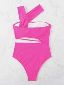 Close-up of pink one-shoulder cut-out swimsuit with ruffled chest on marble background