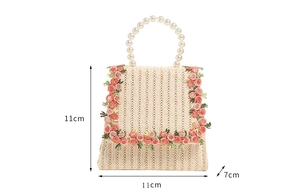 Detailed view of mini straw bag with 11x11x7cm dimensions and pearl bead handle