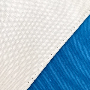 Detailed macro shot showing beige and blue canvas fabric texture with precise stitching