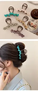 Detailed view of colorful acrylic heart hair claws in five shades with model display